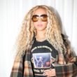 Beyonce Promotes Cowboy Carter in a Chloe Oversized Plaid Cape and A Linda Martell Color Me Country Tee available at Fashion Bomb Daily Shop!